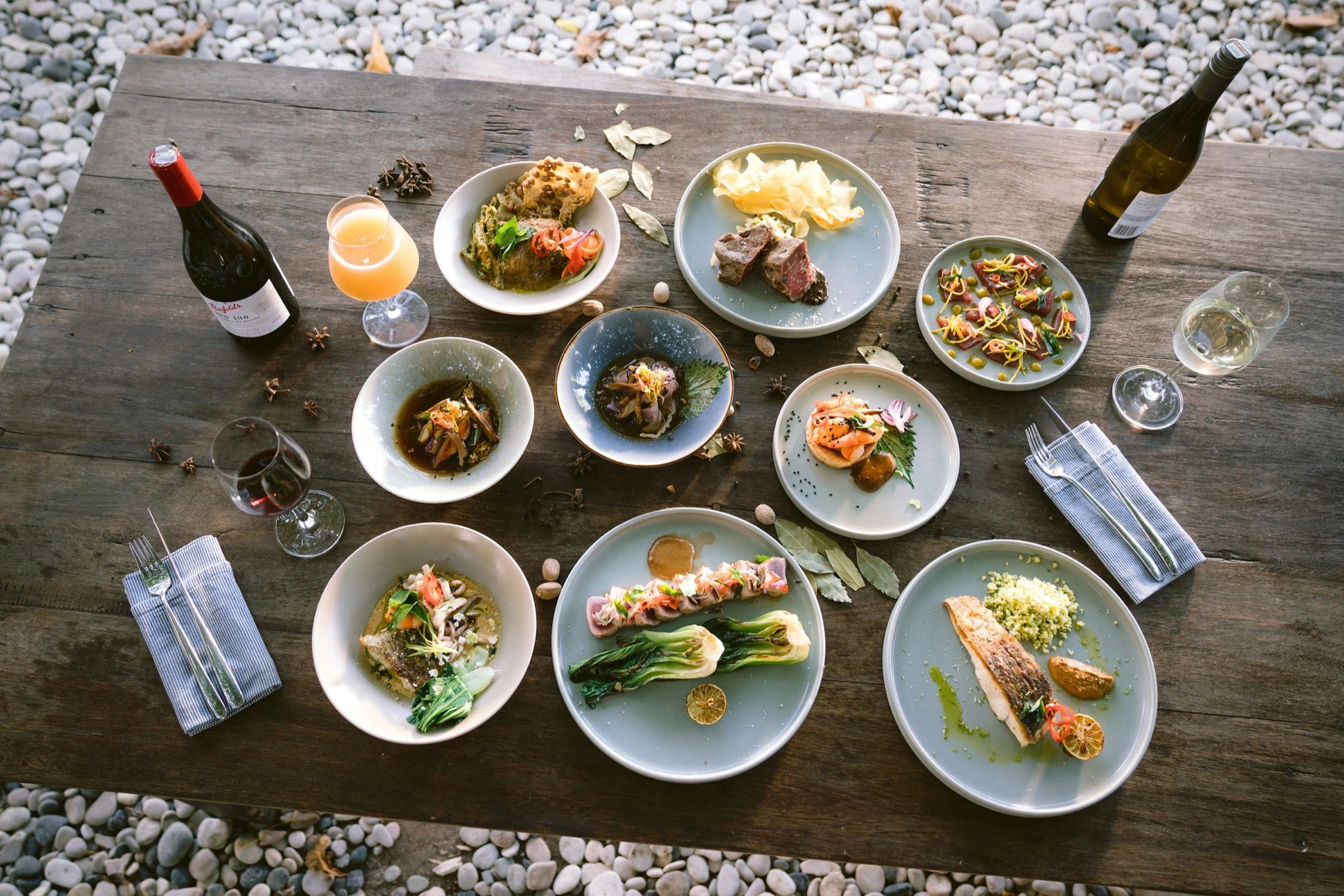 An overhead spread of dishes from the Seed menu in Bingin, Uluwatu
