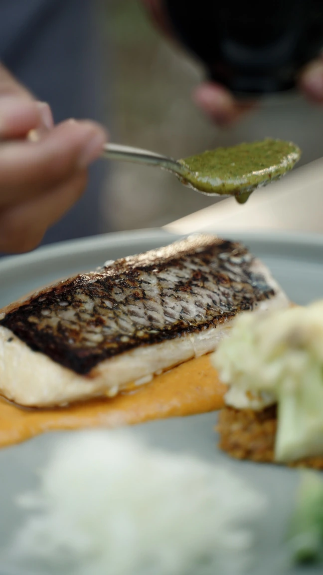 A seared fish fillet finished with sauce at Seed in Bingin