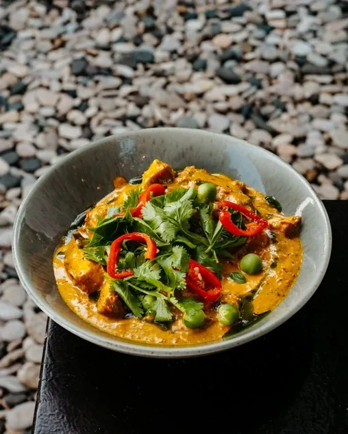 A yellow curry with chilli, coriander and green peppercorns, served in a stone bowl at Seed