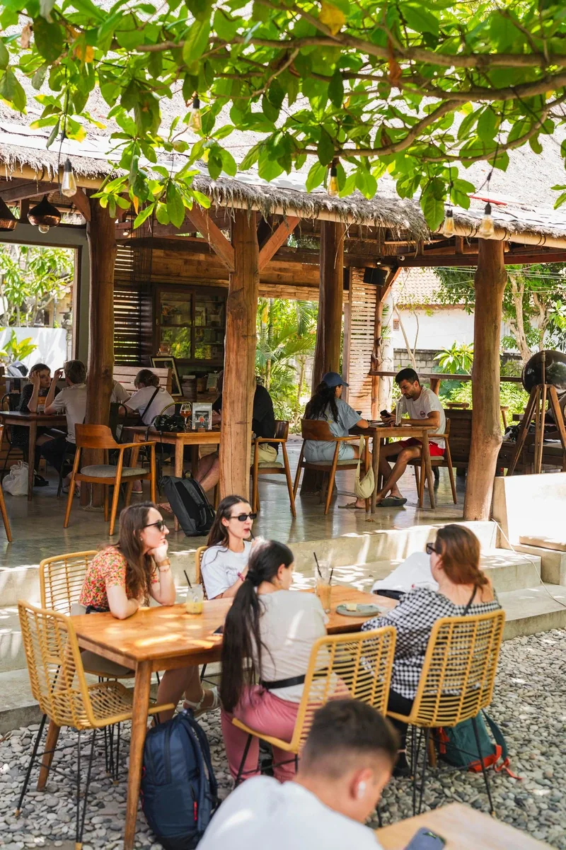 Daytime scene at Seed in Bingin, guests at the tables in the open air dining room